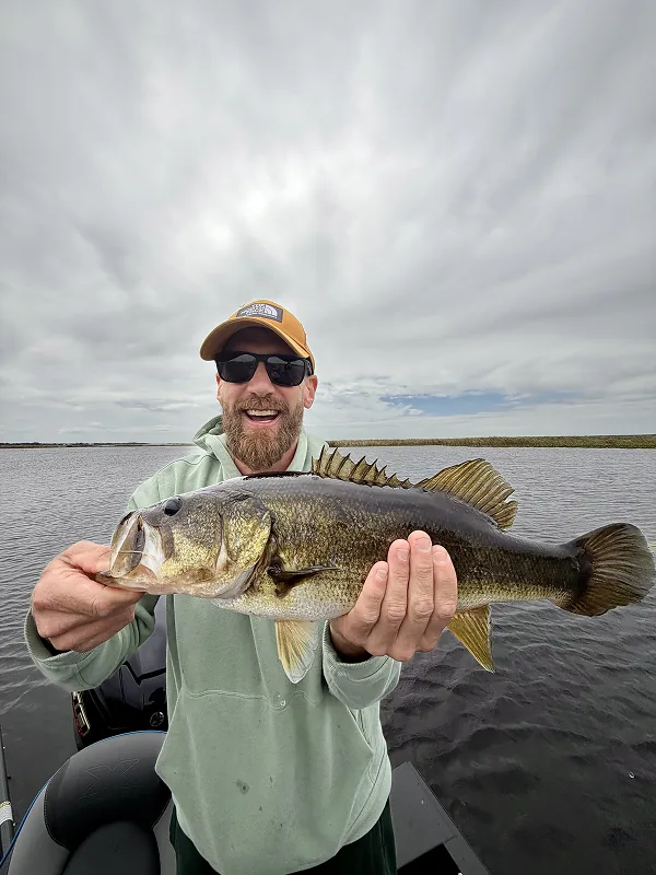 Happy man holding a large bass