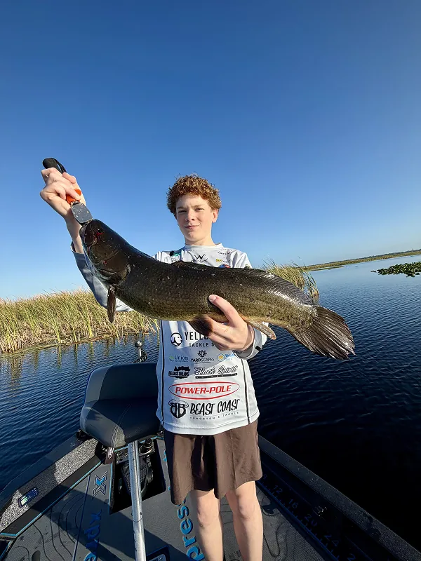 Young man holding a large catch